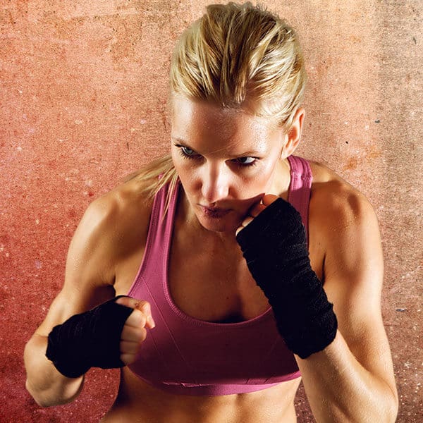 Mixed Martial Arts Lessons for Adults in Eaton CO - Lady Kickboxing Focused Background